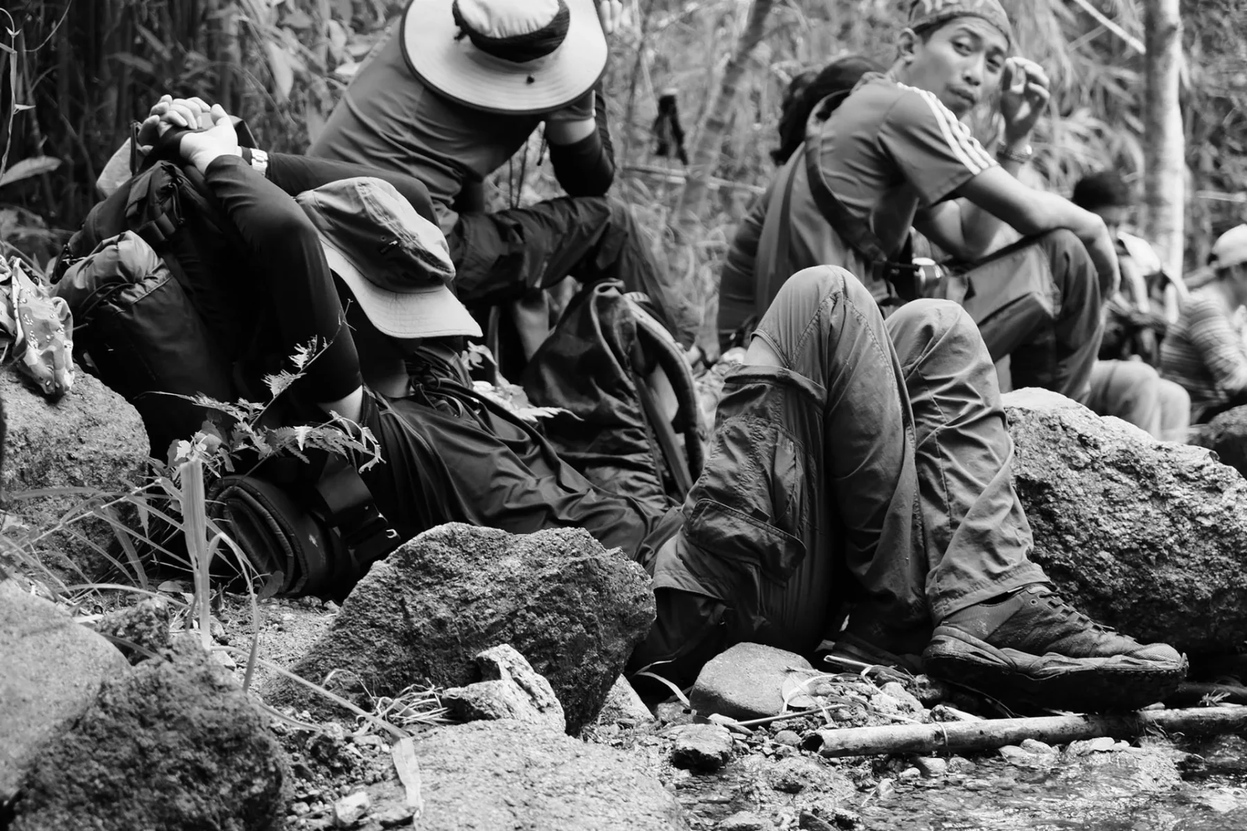 Marc resting on the ground halfway through the mountain trail.