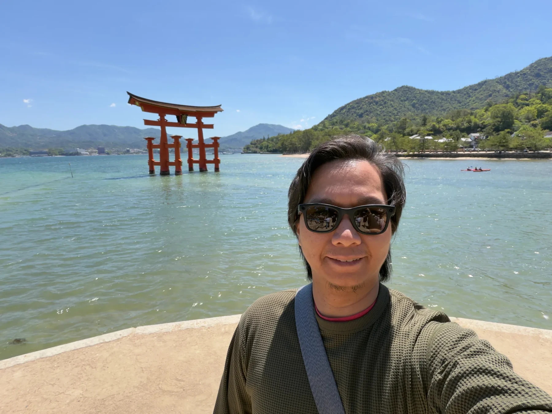 Selfie of me with Itsukushima Shrine and the water behind me on Miyajima.
